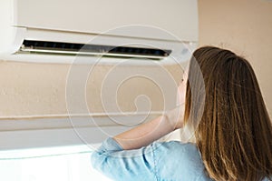 Woman near air conditioner.