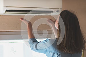 Woman near air conditioner.