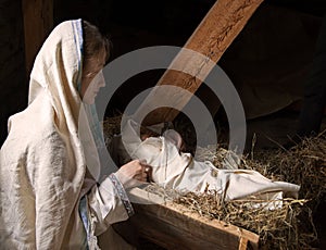 Woman near the baby in the manger