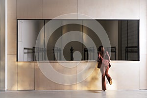 Woman near the counter of the dressing room, rear view