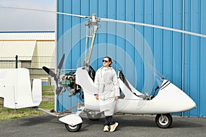 A woman near two-seater white gyrocopter photo