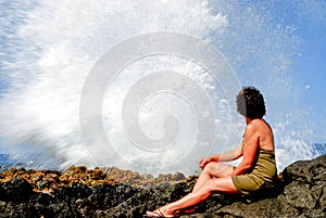 Woman near Le Souffleur geyser at Reunion Island close to Saint Leu city