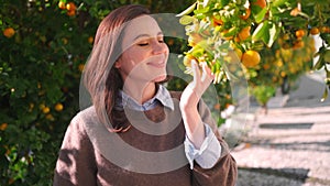 Woman near mandarin tree