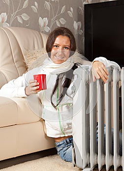 Woman near oil heater