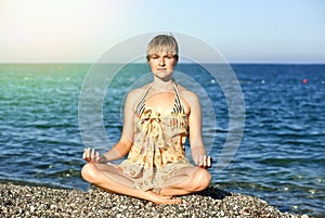 Woman near the sea in the lotus position