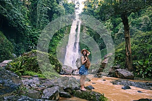 Woman near waterfal Git Git on Bali, Indonesia