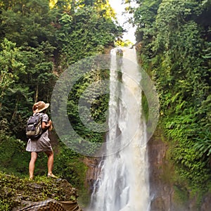 Woman near waterfal Git Git on Bali, Indonesia