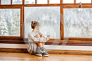 Woman near the window during the winter