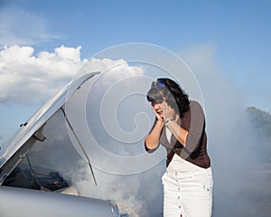 Woman nearby burning car