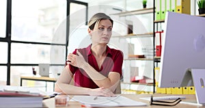 Woman nervously scratches skin of neck in office