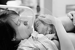 Woman with newborn baby right after delivery