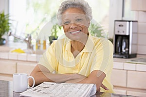 Woman with a newspaper smiling