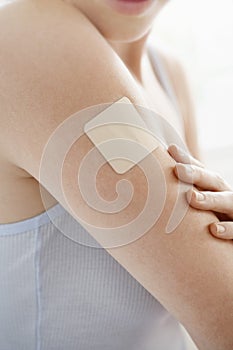 Woman With Nicotine Patch On Arm