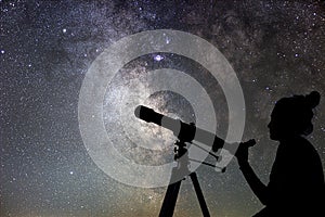 Woman and night sky. Watching the stars Woman with telescope.