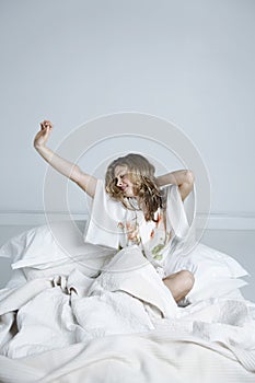 Woman In Nightwear Stretching In Bed photo