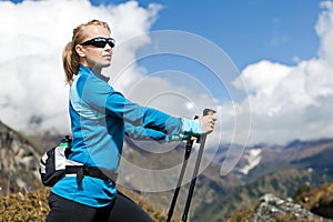 Woman nordic walking and exercising in mountains