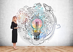 Woman with notebook near strategy plan and lightbulb on grey wall