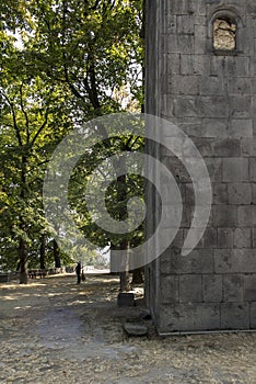 Woman, nun cleaning the square in front of Sanahin Medieval Mona