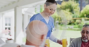 Woman, nurse and breakfast juice in elderly care for meal, snack or beverage at retirement home. Female person, doctor