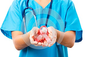 Woman nurse in clinic uniform holding support HIV AIDS awareness red ribbon