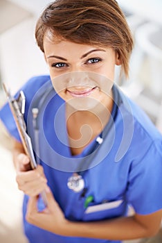 Woman, nurse and happy portrait with clipboard in medical office, nutritionist and stethoscope, professional nursing