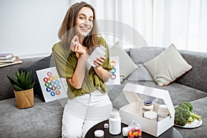 Woman with nutritional supplements at home