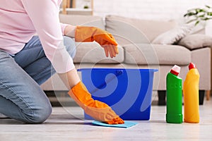 Woman with obsessive compulsive disorder cleaning floor photo