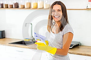 Woman with obsessive compulsive disorder cleaning kitchen with detergents, but everything is clean anyway.