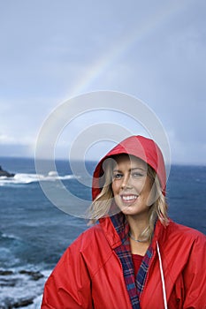 Woman by ocean and rainbow in Maui, Hawaii.