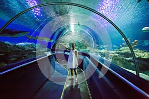 Woman in the oceanarium near alligator gar fish