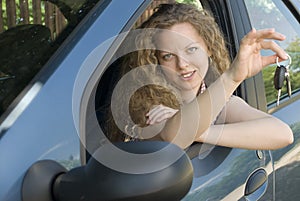 Woman offering keys to her new car