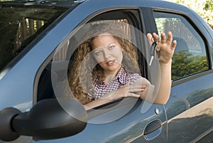 Woman offering keys to her new car