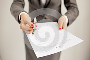 Woman offering to sign papers photo