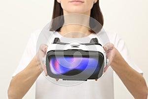 Woman Offering VR Headset on White Background