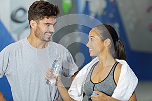 woman offering water to sports companion photo