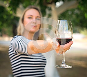 Woman offering wine.