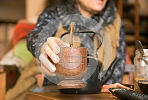 Woman offering yerba mate drink