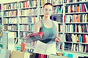 Woman offers a book in a bookstore