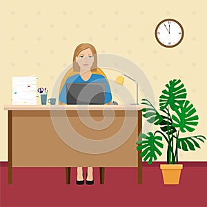 A woman in the office at the Desk with a pile of papers