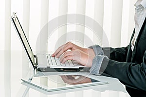 Woman in office with laptop computer com