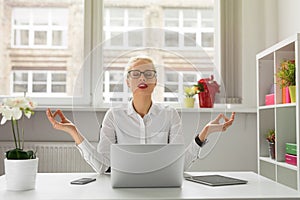 Woman in office meditating