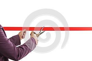 Woman in office suit cutting red ribbon on white, closeup