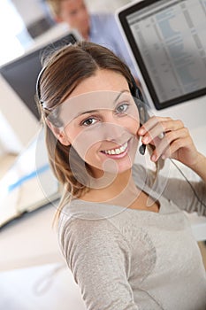 Woman in office talking on headset