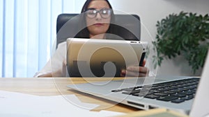 Woman in office using blank screen tablet