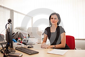 Woman office worker at desk