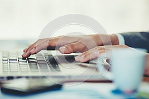 Woman in office and working on her laptop