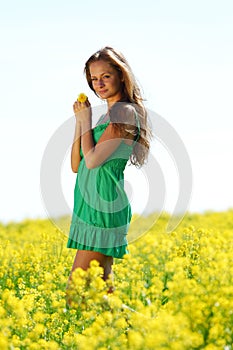 Woman on oilseed field