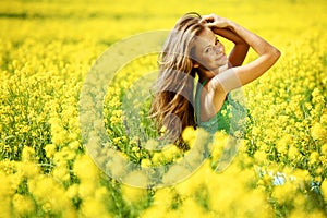 Woman on oilseed field