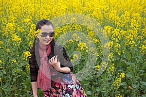 Woman and oilseed flowers