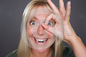 Woman with Okay Sign in Front of Face